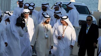 The Ruler of Dubai Mohammed bin Rashid Al Maktoum (C) arrives at the Abu Dhabi Formula One Grand Prix at the Yas Marina circuit (AFP PHOTO / KARIM SAHIB)