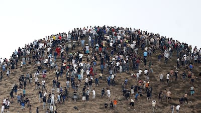People gather on a hilltop close to the site of clashes near Fnideq, on the Moroccan side of the border. AFP