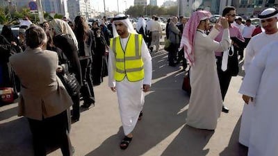 An emergency officer speaks over a loud speaker after people were evacuated from Al Mamoura Building A in Abu Dhabi on April 9. An earthquake orginating in Iran was felt by the capital and people were evacuated as a precaution. Christopher Pike / The National