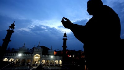 A Muslim man prays as devotees gather to look a the moon, ahead of holy month of Ramadan, at historical Moti Masjid in Bhopal,. Sanjeev Gupta / EPA