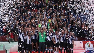 Juventus players celebrate with the trophy after winning the Coppa Italia on Wednesday night in Rome. Alessandro di Meo / EPA
