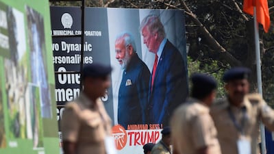 Policemen stand in front of a billboard displaying a picture of India's Prime Minister Narendra Modi and US President Donald Trump in Ahmedabad, ahead of Trump's arrival. AFP