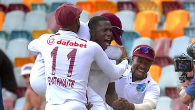 Shamar Joseph celebrates with West Indies teammates after picking up his seven wicket that secured victory. EPA