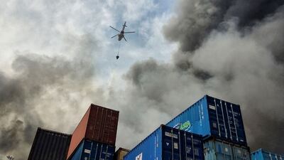A helicopter extinguishes fire following an explosion at the Shahid Rajaee port in Bandar Abbas, Iran on April 27. Wana