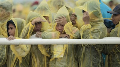Filipinos brave heavy rain and strong winds as they listen to a mass delivered by Pope Francis in Tacloban on January 17. Wally Santana/AP Photo