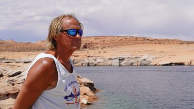 Joe Lapekas, owner of Lake Powell Paddleboards in Page, Arizona, looks out at the water.