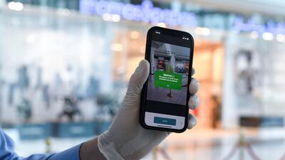 Anyone wishing to enter Al Wahda Mall is scanned, and needs a green result showing they have tested negative for Covid-19.