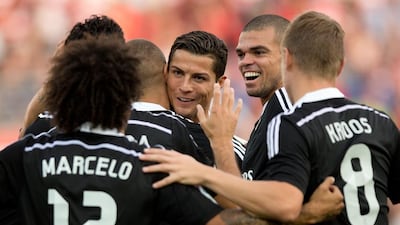 Cristiano Ronaldo, third from the right, is embraced by his Real Madrid teammates during their 4-0 win in their Primera Liga match at Granada on November 1, 2014. Gonzalo Arroyo Moreno / Getty Images