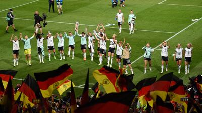 Germany celebrate their win in front of their fans after the final whistle. Getty
