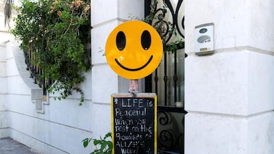 A happiness blackboard sign is pictured outside a house in Umm Suqeim in Dubai, UAE. Reem Mohammed / The National