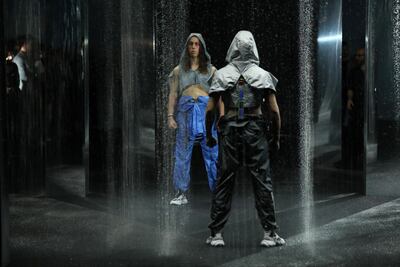 MCM’s debut show at Pitti Uomo opened with two male models standing in sheets of artificial rain