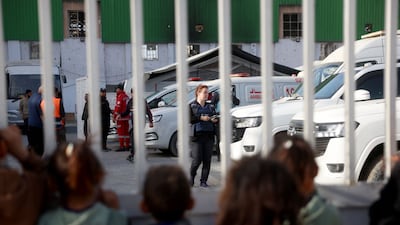 Palestinian children watch in Khan Younis as Gazans injured in the war and other patients prepare to leave for treatment through the Rafah border crossing between the Gaza Strip and Egypt on February 8, 2026. AFP