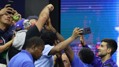 Novak Djokovic of Serbia waves to fans as he leaves the court. AFP