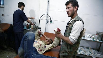 A wounded Syrian boy awaits treatment by doctors at a makeshift hospital in the rebel-held area of Douma, east of the capital Damascus, following reported airstrikes on the city on May 11, 2015. Abd Doumany/AFP Photo