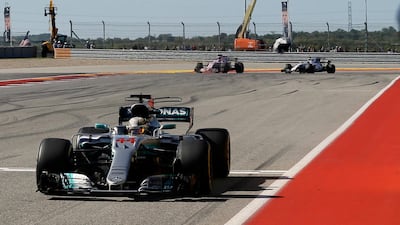 Mercedes driver Lewis Hamilton crosses the finish line to clinch the win and move a step closer to winning the world title. Tony Gutierrez / AP Photo