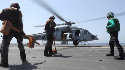 An MH-60S Sea Hawk helicopter from the "Nightdippers" of Helicopter Sea Combat Squadron (HSC) 5 lands on the flight deck of the Nimitz-class aircraft carrier USS Abraham Lincoln (CVN 72) during a replenishment-at-sea operation. US Navy