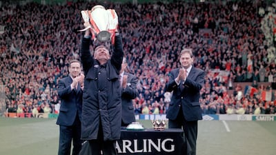 Alex Ferguson holds the Premier League trophy after the final home game of the 1996-97 season, which they won with 75 points. Getty
