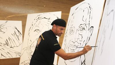 Artist Tachi Pintor holds his first regional exhibition with a live painting of Emirati race driver, Khaled Al Qubaisi at Avenue at Etihad Towers in Abu Dhabi. Sarah Dea / The National