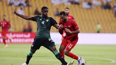 UAE's Kouame Kouadio and Bahrain's Ebrahim Al Khatal in action.