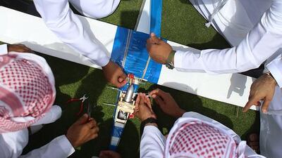 Emirati students, featured in a story on April 23, participating in the 2014 Innovation Challenge in Abu Dhabi prepare their aerial vehicle before lift-off. Delores Johnson / The National