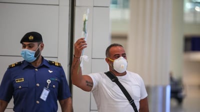 Passengers from Beirut are presented with white roses on arrival at Dubai International Airport last night. Courtesy: Dubai Customs