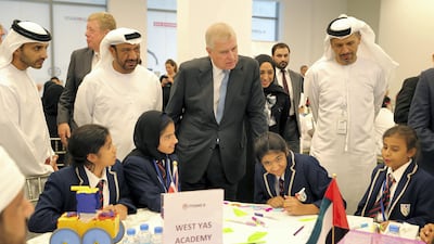 Prince Andrew, Duke of York, centre, talks to the students of West Yas Academy during his visit to “The Make it Challenge” an initiative to design, create , cost and market an unmanned rescue vehicle held at the Khalifa University in Abu Dhabi. Pawan Singh / The National