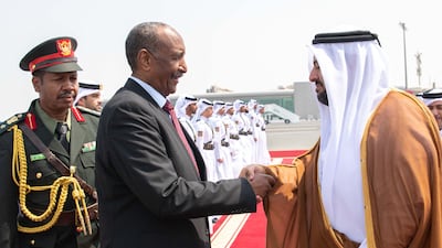 Mr Al Khulaifi greets the Sudanese army chief during his visit to Doha. AFP / Qatar News Agency