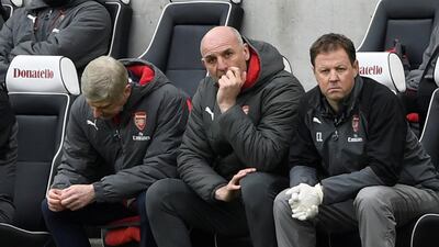 Arsene Wenger, left, sits in the dugout during Arsenal's defeat at Brighton and Hove Albion on Sunday. Tony O'Brien / Reuters