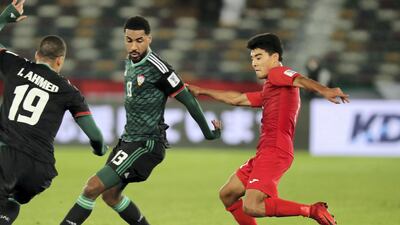 Khamis Esmaeel, centre, blocks the ball.