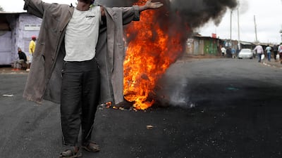 A supporter of Kenyan opposition leader Raila Odinga gestures in front of a burned barricade in a slum in Nairobi. Goran Tomasevic / Reuters