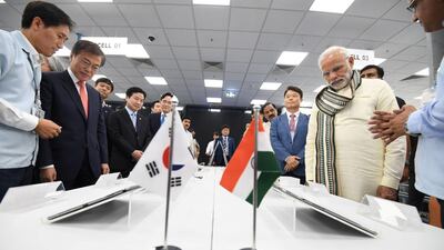 India's Prime Minister Narendra Modi and South Korea's President Moon Jae-in take a tour inside the Samsung Electronics smartphone manufacturing facility after it's inauguration in Noida, India. Press Information Bureau via Reuters