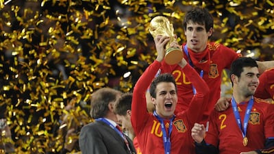 Cesc Fabregas holds aloft the World Cup after helping the senior team win in 2010. Javier Soriano / AFP
