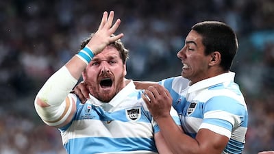 Argentina hooker Julian Montoya, left, celebrates the second of his three tries in the win over Tonga at the Tokyo Stadium. AFP