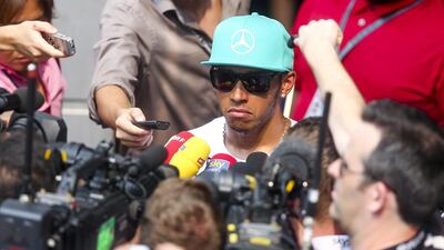 British Formula One driver Lewis Hamilton of Mercedes surrounded by reporters at the paddock at the end of the second practice session ahead of the Malaysian Formula One Grand Prix at the Sepang International Circuit, near Kuala Lumpur, Malaysia on March 28 2014. EPA/DIEGO AZUBEL