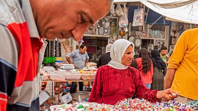 A woman shops for sweets at the main market of the Kurdish-majority city of Qamishli in Syria's northeastern Hasakeh province on May 19, ahead of Eid. Delil Souleiman / AFP