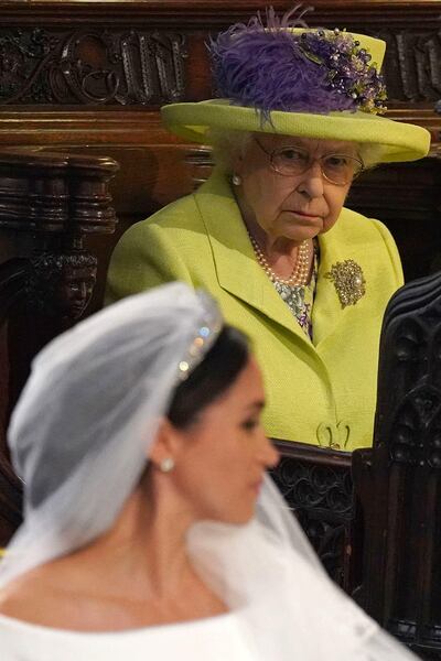 Britain's Queen Elizabeth II looks at the Duchess of Sussex on her May 2018 wedding day. AFP