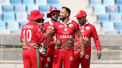 Oman's Fayyaz Butt celebrates after taking the wicket of Lega Siaka.