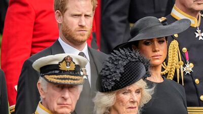 Prince Harry and Meghan watch as the coffin of Queen Elizabeth II is placed into the hearse following the state funeral service in September 2022. AP