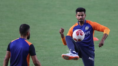 India's Shreyas Iyer passes a football during training. AP
