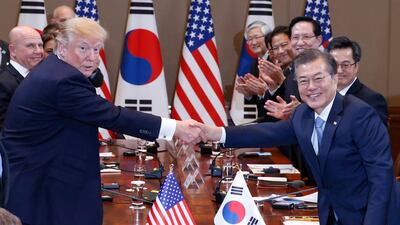 US president Donald Trump and South Korean president Moon Jae-in shake hands before their summit meeting at the presidential house in Seoul, South Korea. Jeon Heon-Kyun / EPA