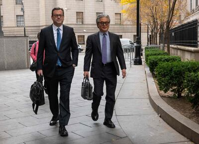 Sung Kook "Bill" Hwang and one of his lawyers arrive for the sentencing hearing. Getty / AFP