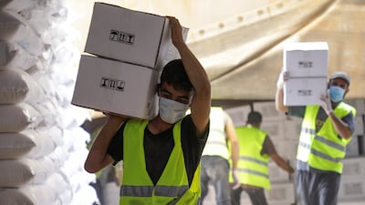 Workers carry boxes of humanitarian aid near the Bab Al Hawa crossing at the Syrian-Turkish border in Idlib. Reuters