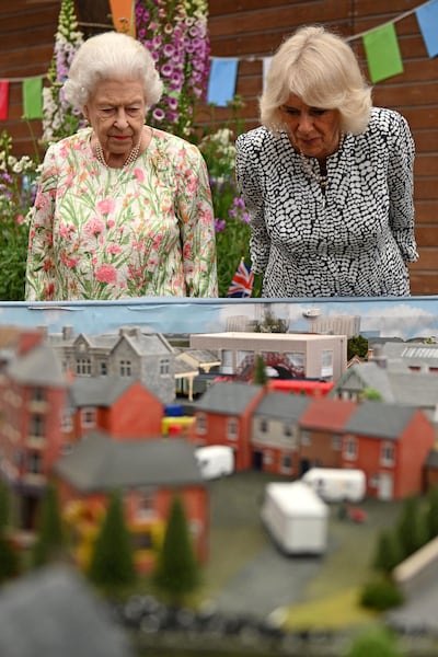 Britain's Queen Elizabeth and Camilla, Duchess of Cornwall look at a scale model of Big Lunch events, as they attend a drinks reception on the sidelines of the G7 summit. Reuters