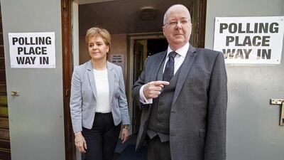 Scotland’s First Minister and Leader of the Scottish National Party (SNP), Nicola Sturgeon, left, and her husband Peter Murrell vote in east Glasgow. Robert Perry / AFP Photo