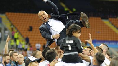 Real Madrid players throw manager Zinedine Zidane in the air in celebration after winning the Uefa Champions League. Stefan Wermuth / Reuters