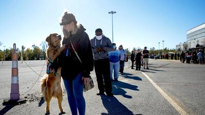 Aaryn Dupske waits in line, accompanied by her service dog, to vote in St. Charles, Missouri. AP