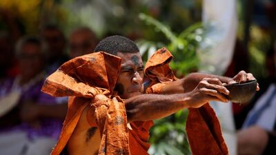 A man offers a bowl of kava to the royal couple. Reuters.