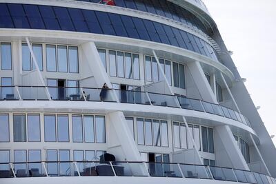 Passengers look from their balconies of the Royal Caribbean's 'Quantum of the Seas' cruise ship after a passenger tested positive for Covid-19 during a cruise to nowhere. Reuters