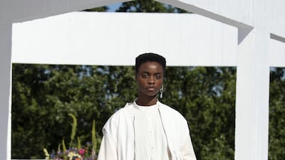 An all-white look with a shirt covered in small, precise pleats. Courtesy Qasimi