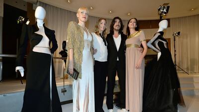 French designer Stephane Rolland poses with actresses Anna Sherbinina, Natacha Regnier and Frederique Bel during the presentation of his Haute Couture Fall-Winter 2014/15 collection during Paris Fashion Week. EPA